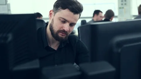 Worker sitting on working place in front of PC Video stock 73467320
