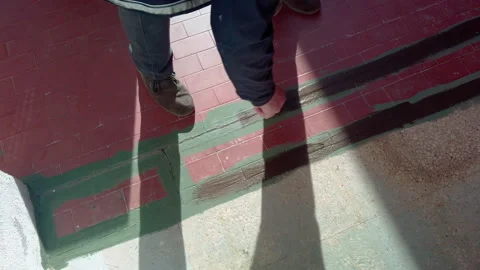 Worker skillfully spreading asphalt with a precision brush for insulation Stock Footage 293227800