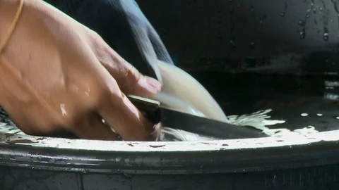 A worker slicing a raw fish with a knife Stock Footage 120021625