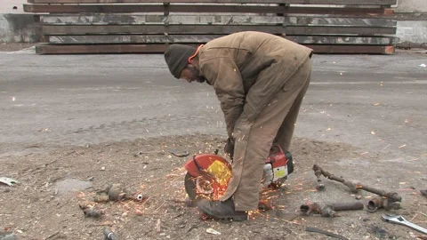 Worker Slicing through Pipe with Saw at Deconstruction Site in Bonner Stock Footage 134210210