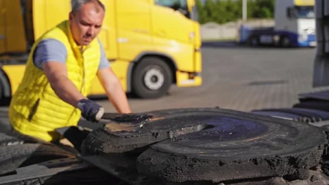 A worker smearing trailer fifth wheel coupling with lubricant oil. Semi-truck Stock Footage