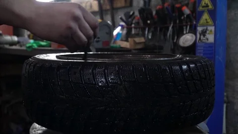 Worker smears wheels Stock Footage 84284287