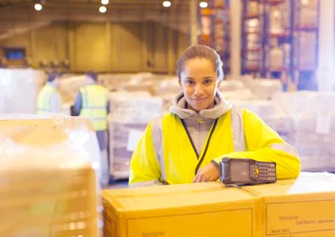 Worker smiling in warehouse Stock Photos