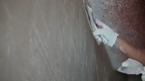 Worker Smoothing Fresh Plaster on Wall with Trowel Stock Footage 317380127