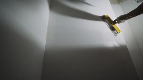 Worker smoothing interior wall with plastering tool Stock Footage 314234817