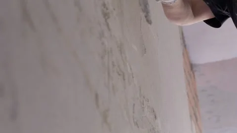 Worker smoothing plaster on wall with wide trowel Stock Footage 346550724