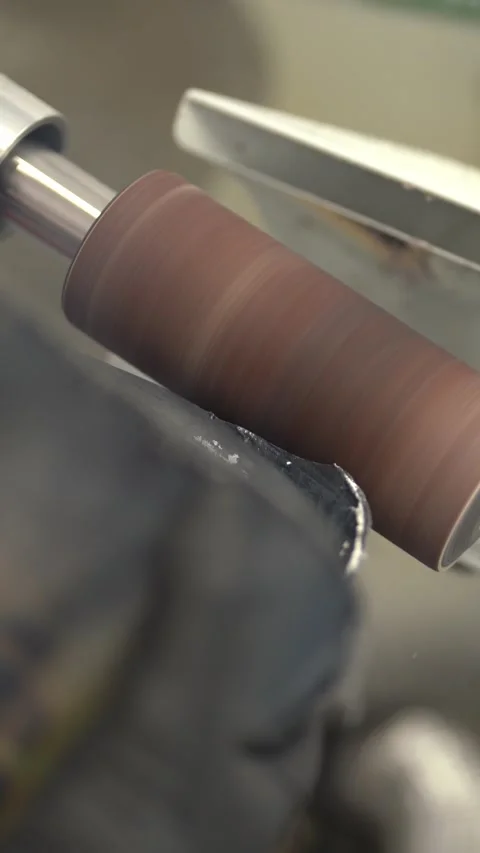 Worker smoothing prosthesis with sander in factory. Vertical video Stock Footage 237607826