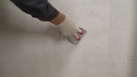 Worker smoothing wall with trowel Stock Footage 338385865