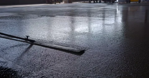 A worker smooths the surface of the concrete with a mop Stock Footage 161988006