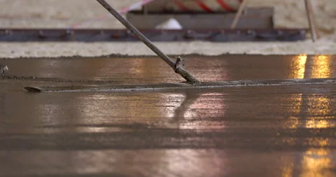 A worker smooths the surface of the concrete with a mop Stock Footage 161990392