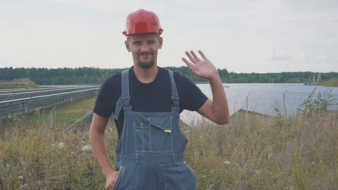 A worker at a solar power station. Smiling and waving his hand Stock Footage 94558029