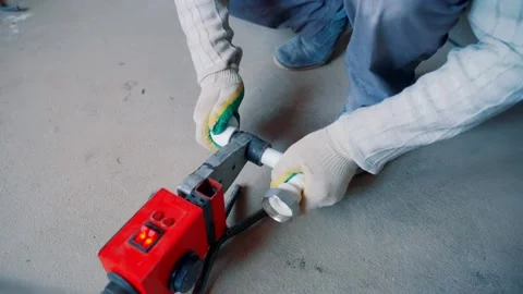 A worker solders polypropylene corners for heating and water supply. Stock Footage 139668774