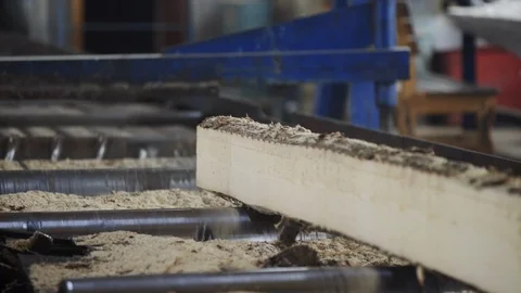 Worker sorting boards after cutting. Sawmill. Manufacturing. Outdated sawmill Stock Footage 127041953