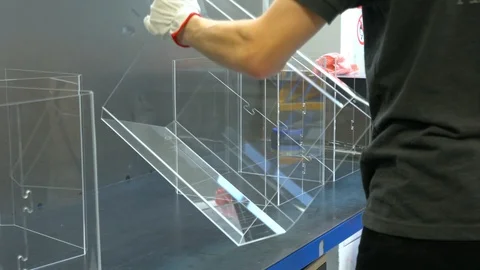 Worker sorting plastic parts, after cnc milling cutting. Man collects order Stock Footage 119398297