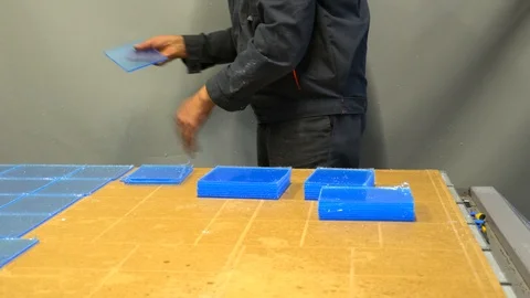 Worker sorting plastic parts, after cnc milling cutting. Man collects order Stock Footage 119398298