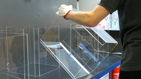 Worker sorting plastic parts, after cnc milling cutting. Man collects order Stock Footage 119398307