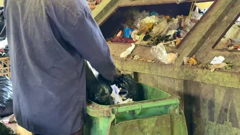 Worker sorting recyclable garbage inside a recycling facility. Stock Footage 342748464
