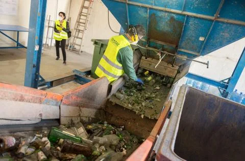 Worker is sorting the recyclable glass material and removing non recyclable t Stock-Fotos