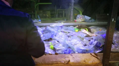 Worker sorts out debris on the conveyor Stock Footage 48679894