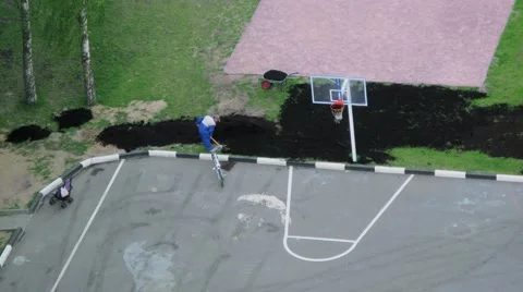 Worker with spade spreads black ground near sports playground Stock Footage 68340386