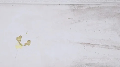 Worker with a spatula in his hands rips off the plaster Stock Footage 126832254