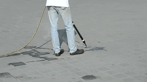 Worker with special device and long metal hose cleaning the street, hot steam. Stock Footage 46691196