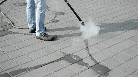 Worker with special device clear the street with hot steam technology. Stock Footage 46443858
