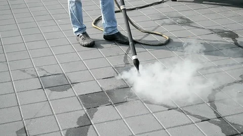 Worker with special device, metal hose clear the street with hot steam. Stock Footage 46449591