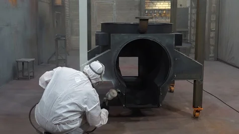 Worker in special protective suit and mask paints metal, industrial painting Stock Footage 120062689