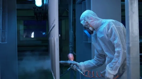 Worker in special suit spraying hazardous paint, breathing mask cleaning filter Stock Footage 117985455