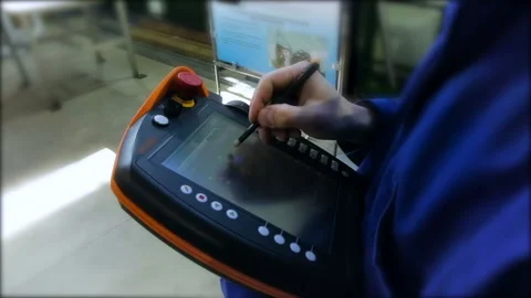 The worker on the special tablet marks the necessary items for adjusting the Stock Footage 93272524