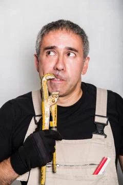 Worker specialist plumber, engineer or constructor with wrench Stock Photos