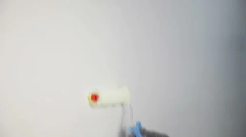 Worker spends anchor roller on the wall Stock Footage 61418974