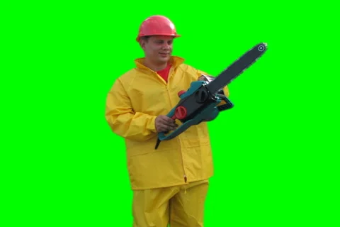 Worker spins with chainsaw on the Green Screen LOOP NTSC Stock Footage 1059429