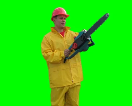 Worker spins with chainsaw on the Green Screen LOOP PAL Stock Footage 1059431