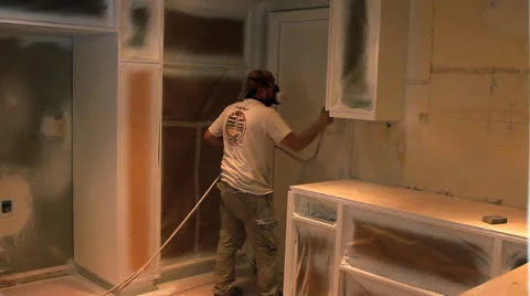 WORKER SPRAY PAINTING KITCHEN Stock Footage 22952531