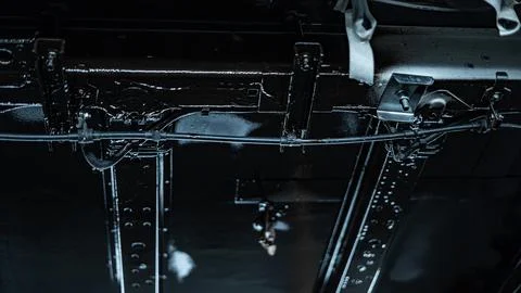 Worker Spraying Protective Undercoating Beneath a Car in Auto Workshop Stock Photos