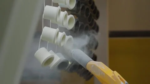 A Worker is Spraying the White Paint on the Black Light Bulb Sockets. Coloring. Video stock 155865021