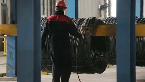 Worker sprays paint on the rods Stock Footage 72714300