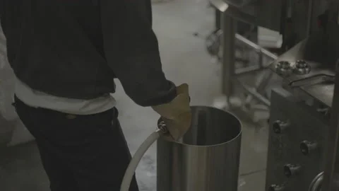 Worker sprays small metal container with hose Video stock 202732715