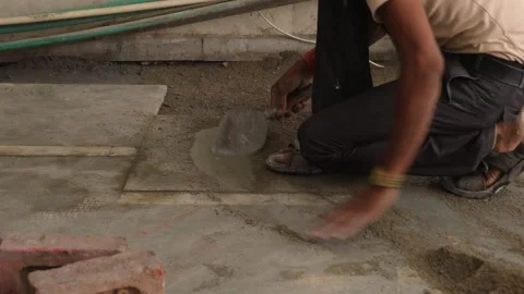 Worker Spreading cement powder with the help of spade. Stock Footage 245101412