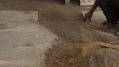 Worker Spreading cement powder with the help of spade. Stock Footage 245101458