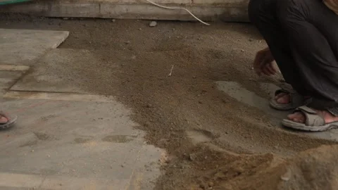 Worker Spreading cement powder with the help of spade. Stock Footage 245101568