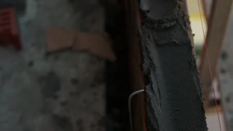 Worker spreading mortar on masonry surface with trowel Stock Footage 346549963