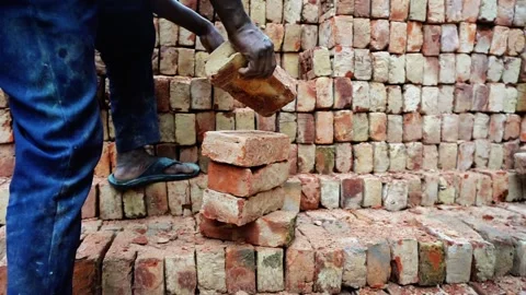 Worker Stacking Bricks By Hand Stock Footage 320958539
