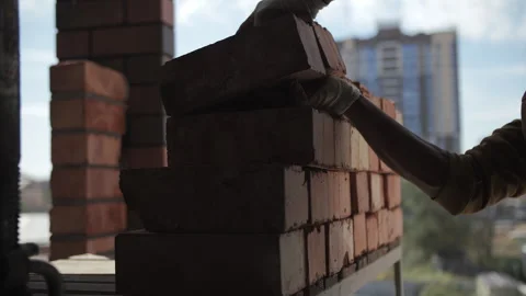 Worker stacking bricks in a neat pile Stock Footage 300336323
