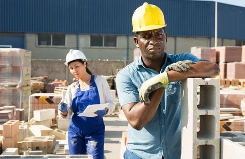 Worker stacking bricks in warehouse of building materials clpseup 写真素材
