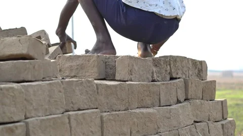 Worker Stacking Clay Bricks for Brick Kiln Firing Traditional Brick Making. Stock Footage 329131183