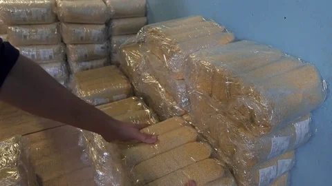 Worker stacking packing with millet Stock Footage 82901398