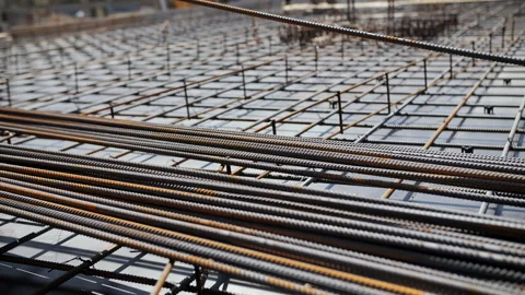 Worker stacking steel reinforcement bars at construction site Stock Footage 314645246